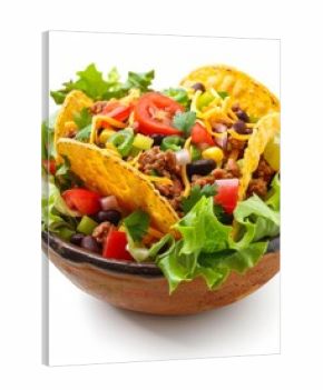 Delicious taco salad featuring crispy tortilla chips, seasoned ground beef, cheese, black beans, corn, tomatoes, onions, lettuce and spices