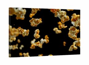 Dynamic macro shot of flying popcorn pieces against a black background. Crisp detail and motion captured in a dramatic, high-contrast composition. Perfect for advertising or creative design.
