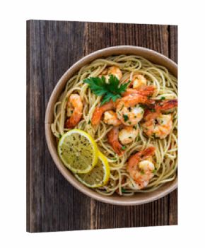 Takeaway food - fried shrimps with noodles and lemon in lunch box to go on wooden table 