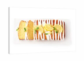 Delicious lemon cake with glaze, fresh fruit slices and mint isolated on white, top view