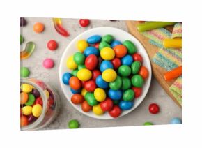 Delicious colorful candies on light table, flat lay