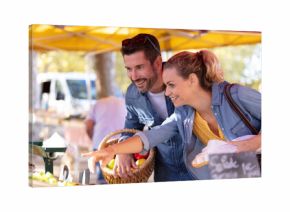couple tourists looking at products on local market