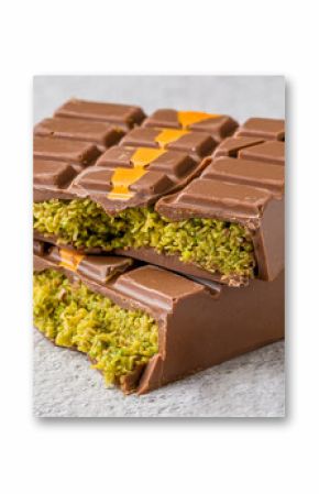 Dubai Chocolate bar with green kadayif and peanut butter on white stone table