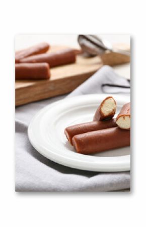 Powdered coffee and tasty curd bars on plate with vanilla on grey background