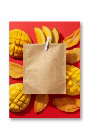 A paper bag with fresh and dried mangoes