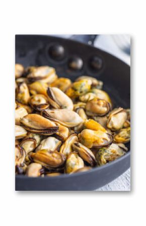 Shelled mussels meat in pan on white table