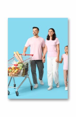 Happy family with full shopping cart holding hands on blue background