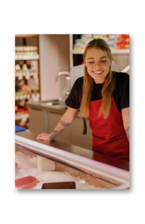 A cheerful fishmonger warmly engages customers at a vibrant and bustling seafood market, overflowing with freshness