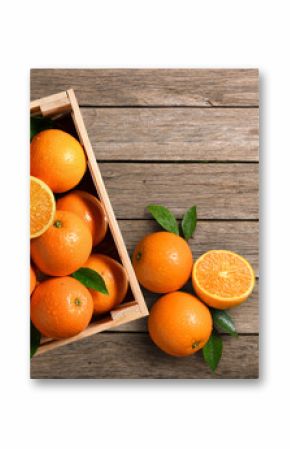 Top view of fresh oranges in wooden crate on wood planks.