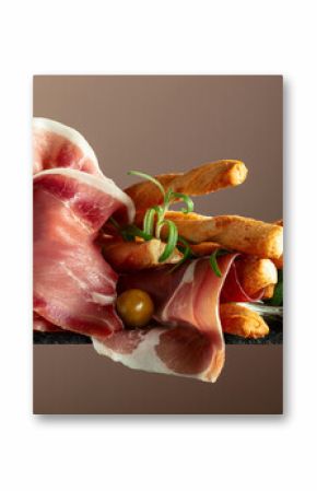 Prosciutto with bread sticks, olives, and rosemary.
