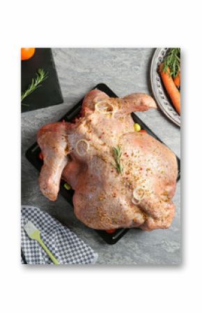 Whole raw turkey with ingredients for marinade and other products on grey table, flat lay