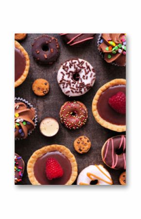 Dessert background with a selection of sweets. Top view on a dark stone background.