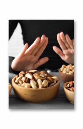 Woman refusing to eat products at grey wooden table, selective focus. Food allergy concept