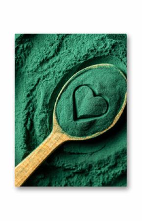Heap green spirulina algae powder in wooden spoon with heart shape, top view on green spirulina powder background. Dietary supplement to improve health. Seaweed superfood concept. Healthy food