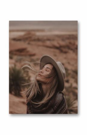  Woman in Hat and Blanket Embracing Wind in Desert Landscape with Earth Tones