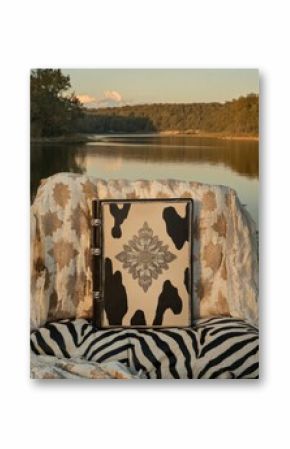 Ornate Cowhide Journal by Serene Lake at Sunset