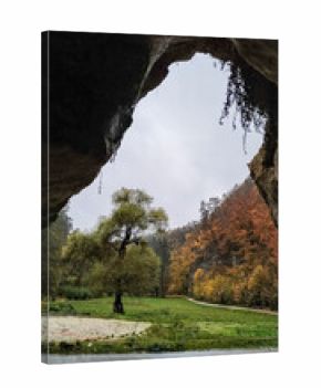 Sandstone rock formation framing autumn landscape in bohemian paradise