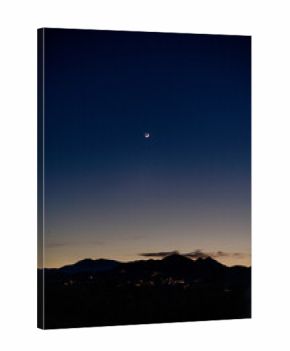 Crescent Moon Over Desert Mountains at Twilight