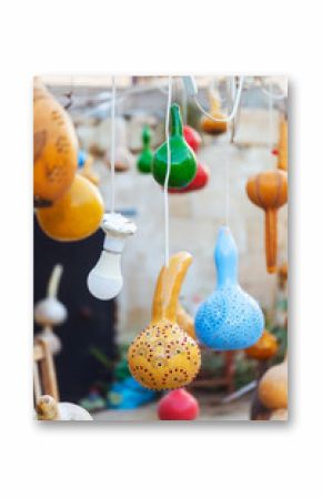 A bunch of vibrant, colorful lanterns gourds beautifully hanging from a string