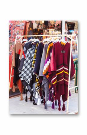 A vibrant assortment of colorful clothes is hanging on a rack