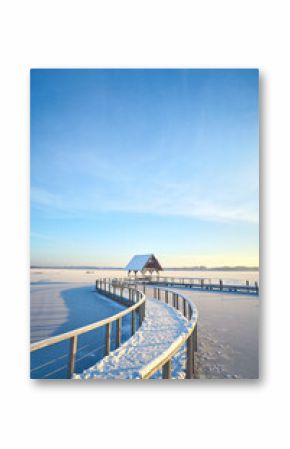 curved footbridge over frozen lake in Hemmelsdorf, northern Germany. High quality photo