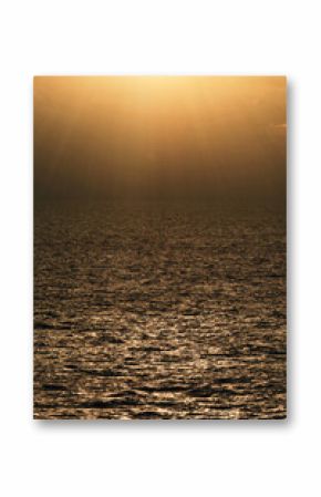 Stunning sunset over calm ocean waters creating a golden reflection in the evening sky