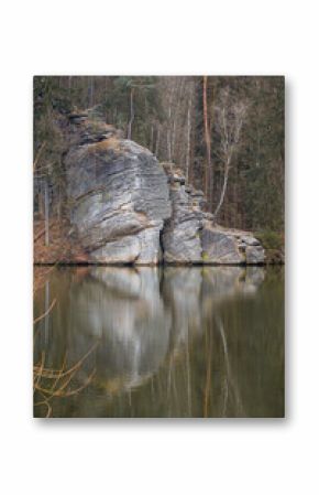 Rock formation reflecting in Vezicky pond at Troskovice, Bohemian Paradise nature reserve, Czech Republic