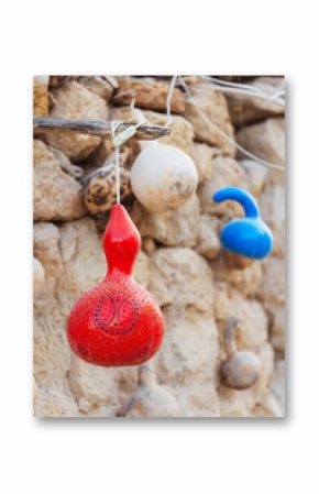 A bunch of vibrant, colorful lanterns gourds beautifully hanging from a string