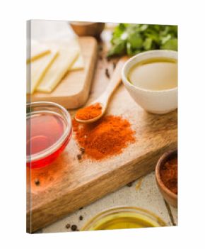 Spices, olive oil and vinegar on cutting board