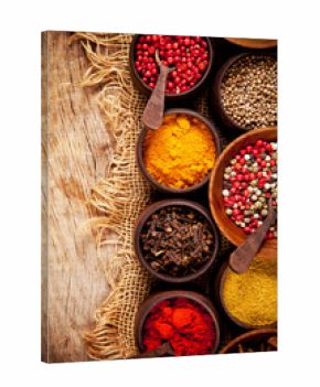 Various kind of spices in wooden bowls