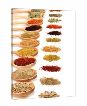 Assortment of spices in wooden spoons, isolated on white