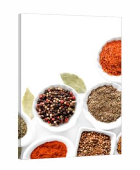 Different kinds of spices in ceramics bowls isolated on white
