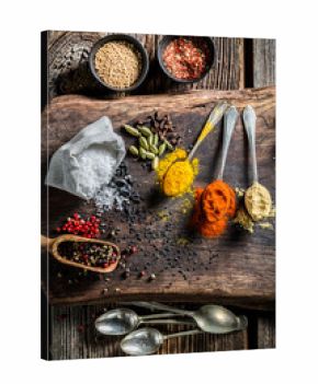 Fresh herbs and spices on old board