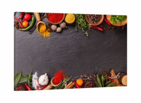 Various spices on black stone