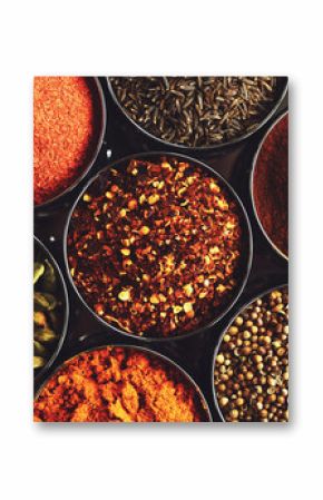 Rack with traditional indian spices for cooking - cardamom, turmeric, cumin, coriander seeds, cinnamon and chili