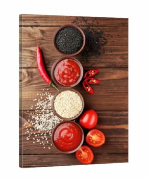 Fresh condiments and sauces on wooden background
