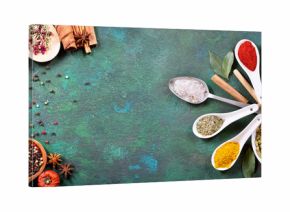 various spices on old green background