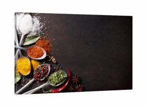 Various spices spoons on stone table