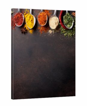 Various spices spoons on stone table