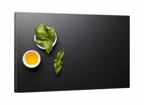 Bazylia i  oliwa z oliwek na czarnym kamiennym tle