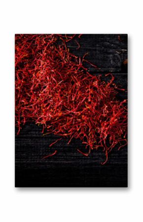 saffron crocus threads on black wooden board