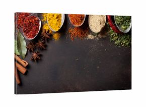 Various spices spoons on stone table