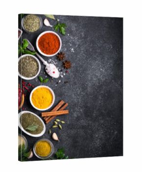 Set of Various spices and herbs on black slate table. 