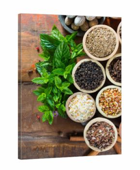 Variety of different asian and middle east spices, colorful assortment, on old wooden table top view