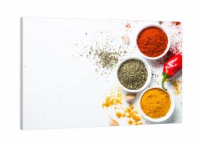 Various spices in a bowls on stone table.