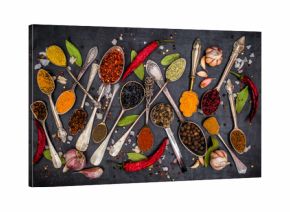 Various spices spoons on stone table. Top view .