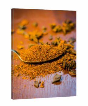 Close up Star aniseed,Illicium verum powder in a antique spoon.