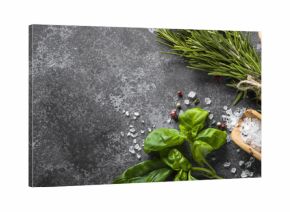 Spices and herbs over black stone table. 