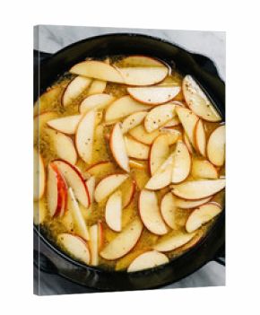 Cooking down apples in cider in an iron skillet