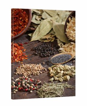 Different spices over a dark wood. Selective focus